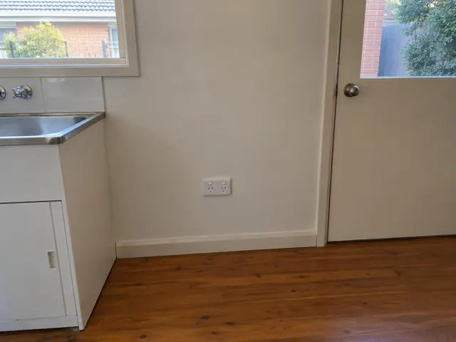 White double power point on a kitchen wall beside a sink and door in Kellyville