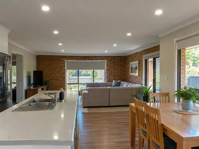 Open-plan kitchen and living room with recessed LED downlights in a home interior in Castle Hill
